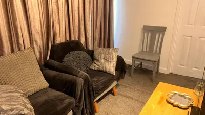 a living room with a couch and a chair at Serene Guest Room Retreat in Basildon with Private Entrance in Basildon
