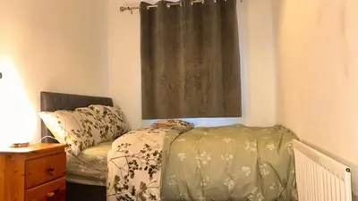 a bedroom with a bed and a window at Serene Guest Room Retreat in Basildon with Private Entrance in Basildon