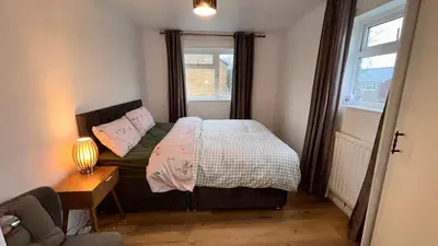 a small bedroom with a bed and a window at Charming 4-Bedroom House Rental in Basildon, UK in Basildon