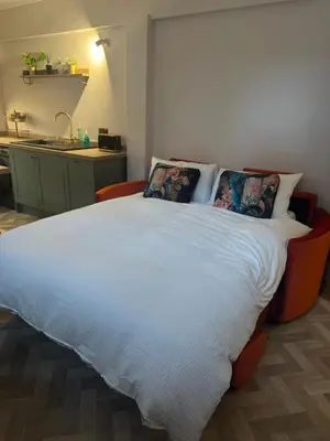 a bedroom with a large white bed with pillows at Half Moon Nest - Refurbished throughout for 2026 in Diss