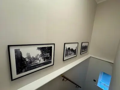 a stairway with three pictures on the wall at Half Moon Nest - Refurbished throughout for 2026 in Diss