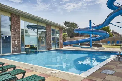 a swimming pool with a water slide in a building at Caravan in Clacton-on-Sea in Little Clacton
