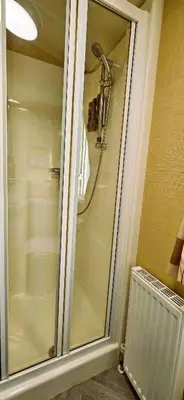 a shower with a glass door in a bathroom at Caravan in Clacton-on-Sea in Little Clacton