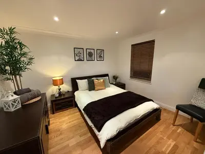 a bedroom with a bed and a desk and a chair at Spacious 5 Bed House - Free Parking & WiFi in Basildon