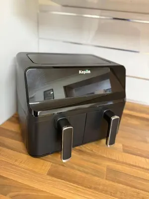 a black toaster oven sitting on a wooden floor at Spacious 5 Bed House - Free Parking & WiFi in Basildon