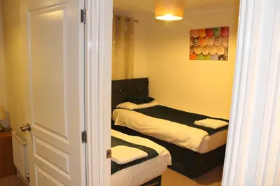 a small bedroom with two beds in it at 4 Bedroom house, Parking, Wi-Fi, Near Town Centre in Ipswich