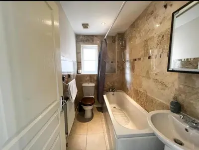 a bathroom with a tub and a toilet and a sink at 4 Bedroom house, Parking, Wi-Fi, Near Town Centre in Ipswich