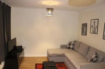 a living room with a couch and a table at 4 Bedroom house, Parking, Wi-Fi, Near Town Centre in Ipswich