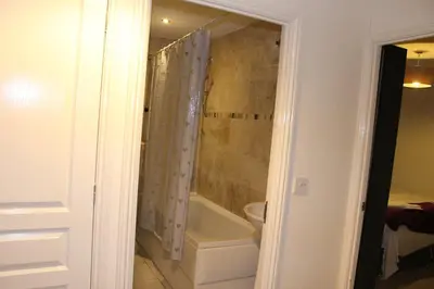 a bathroom with a shower and a bath tub at 4 Bedroom house, Parking, Wi-Fi, Near Town Centre in Ipswich