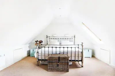 a bedroom with a bed in a attic at Idyllic rural retreat, easy access to Cambridge