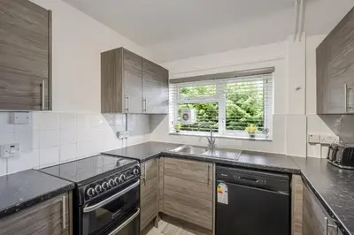 a kitchen with a sink and a stove at Chic & Cosy 2 Bed Maisonette with Freeparking near Chelmsford City Centre in Chelmsford