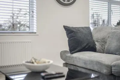 a living room with a couch and a bowl on a table at Chic & Cosy 2 Bed Maisonette with Freeparking near Chelmsford City Centre in Chelmsford