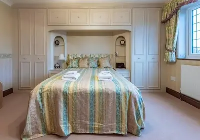 a bedroom with a large bed with towels on it at Tudor Style Seafront Home Sea Views Shoebury - Pass the Keys in Southend-on-Sea