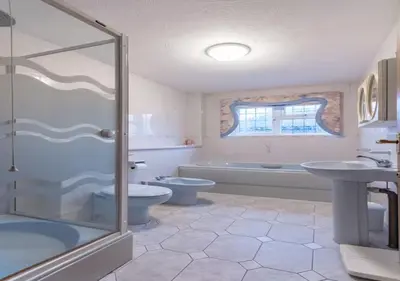 a bathroom with a toilet and a tub and a sink at Tudor Style Seafront Home Sea Views Shoebury - Pass the Keys in Southend-on-Sea