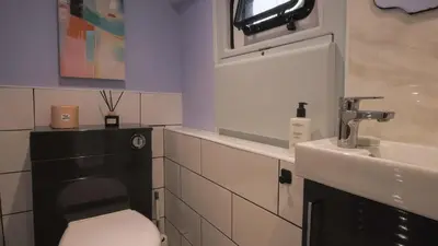 a bathroom with a toilet and a sink at The Carriage Ely in Coveney