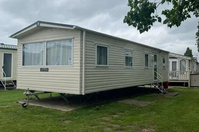 a mobile home is parked in a yard at Cabin - Sleeps 6 - Beach 10 minutes drive in Clacton-on-Sea