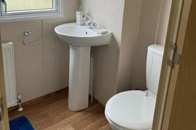 a bathroom with a white sink and a toilet at Cabin - Sleeps 6 - Beach 10 minutes drive in Clacton-on-Sea