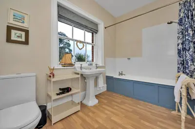 a bathroom with a sink and a tub and a toilet at Finest Retreats - Clavering Hall in Saffron Walden