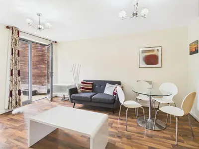a living room with a couch and a table at Station Apartment in Cambridge