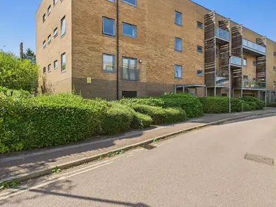 an empty street in front of a brick building at Station Apartment in Cambridge