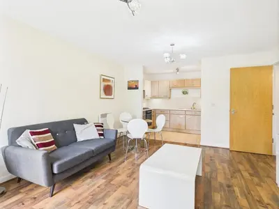a living room with a couch and a table at Station Apartment in Cambridge