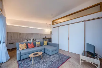 a living room with a blue couch and a tv at The Orchard Annexe, Framlingham in Framlingham
