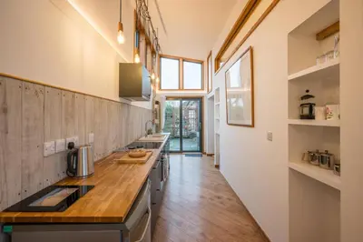 a kitchen with white walls and a wooden counter top at The Orchard Annexe, Framlingham in Framlingham