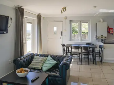 a living room with a couch and a table at Ivy No1 - Uk49251 in Althorne