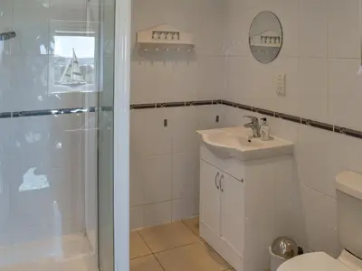 a bathroom with a shower and a sink and a toilet at Ivy No1 - Uk49251 in Althorne