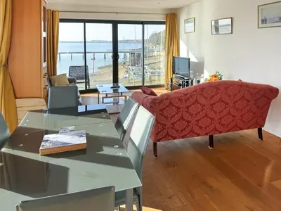 a living room with a couch and a table at Admiralty Lodge in Shotley Gate