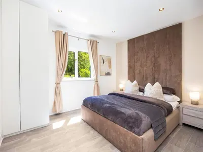 a bedroom with a large bed and a window at Essex Barn House - Uk48354 in Romford