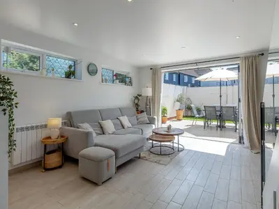 a living room with a couch and a table at Olive Breeze in Felixstowe