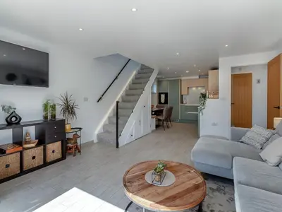 a living room with a couch and a table at Olive Breeze in Felixstowe