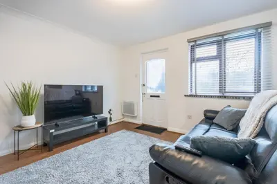 a living room with a couch and a flat screen tv at A lovely modern comfortable one bedroom house - Pass the Keys in Southend-on-Sea