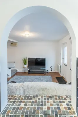 an archway in a living room with a fireplace at A lovely modern comfortable one bedroom house - Pass the Keys in Southend-on-Sea