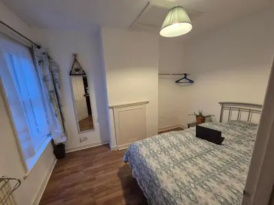 a bedroom with a bed with a laptop on it at Stoke house in Ipswich