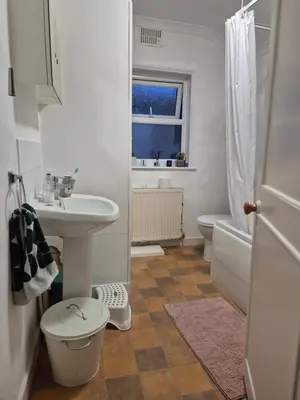 a white bathroom with a sink and a toilet at Stoke house in Ipswich