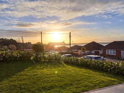 a view of the sunset from a yard with flowers at The Lobster Pot in Shotley Gate