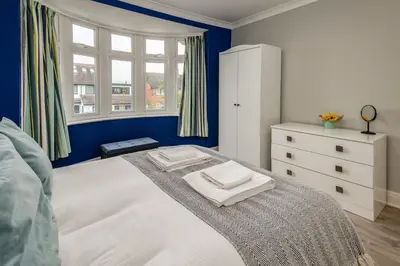 a bedroom with a bed with two towels on it at Stunning City Home with Private Heated Indoor Pool & Cinema Room in Cambridge