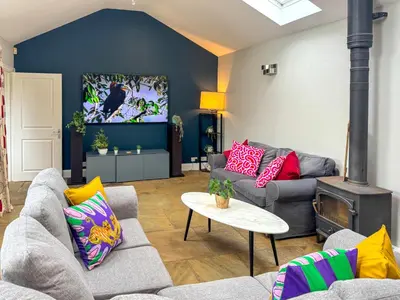 a living room with two couches and a tv at Stunning City Home with Private Heated Indoor Pool & Cinema Room in Cambridge