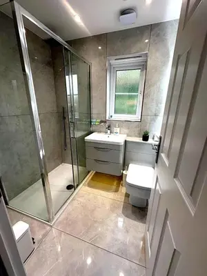 a bathroom with a shower and a toilet and a sink at Luxury home Cheshunt in Wormley