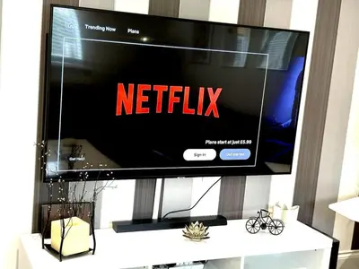 a flat screen tv sitting on top of a white table at Luxury home Cheshunt in Wormley