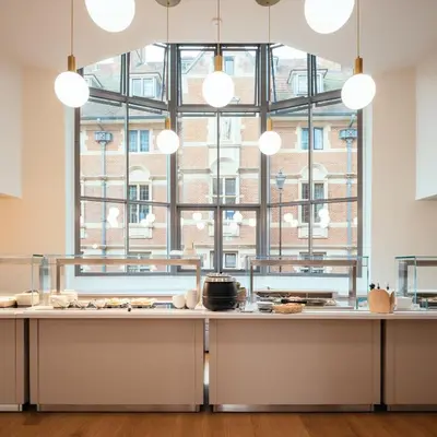 a kitchen with a large window and a large counter top at St Catharine's College, Cambridge in Cambridge