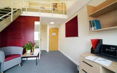 an office with a loft conversion with a desk and a chair at St Catharine's College, Cambridge in Cambridge
