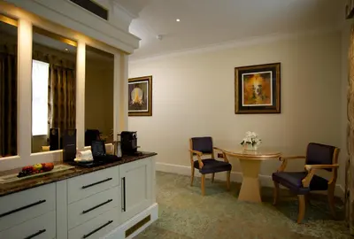 a hotel room with a table and chairs and a room at GreyFriars in Colchester