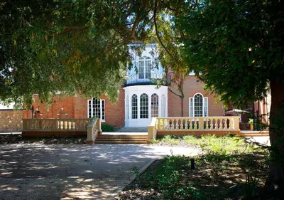 a brick building with a bench in front of it at GreyFriars in Colchester