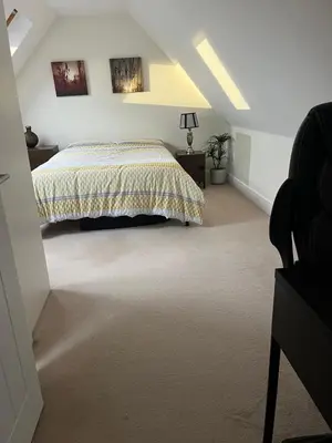 a bedroom with a bed in a attic at Modern Suite with a Queen Bed, Ensuite & Workspace in Chelmsford