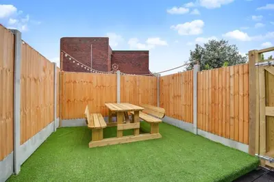 a patio with a picnic table and a fence at Studio Apartment with Private Garden in Southend-on-Sea
