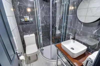 a bathroom with a sink and a toilet and a shower at Studio Apartment with Private Garden in Southend-on-Sea