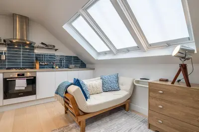a kitchen with a couch and some windows in a room at Charming Central 1Bed Home in Chesterton